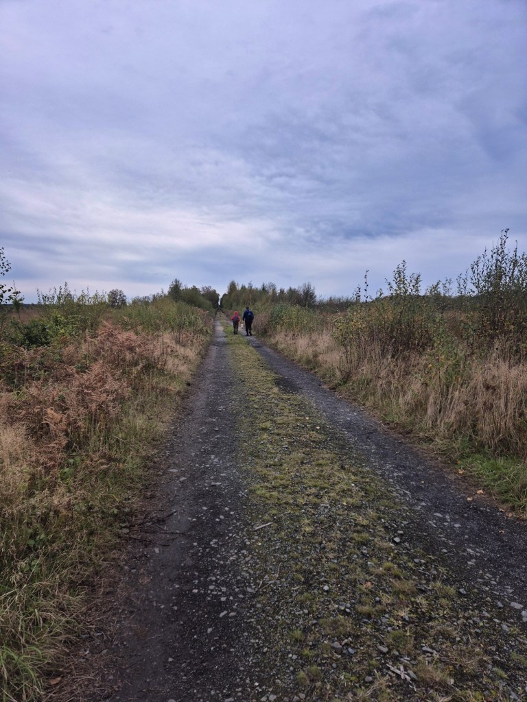 a family walk up a gravel track a disused railway