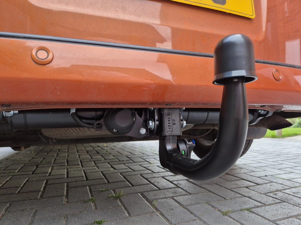Black towbar and electrics fitted to an orange ford transit van