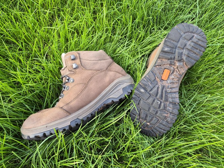 Pair of brown leather walking boots in the grass
