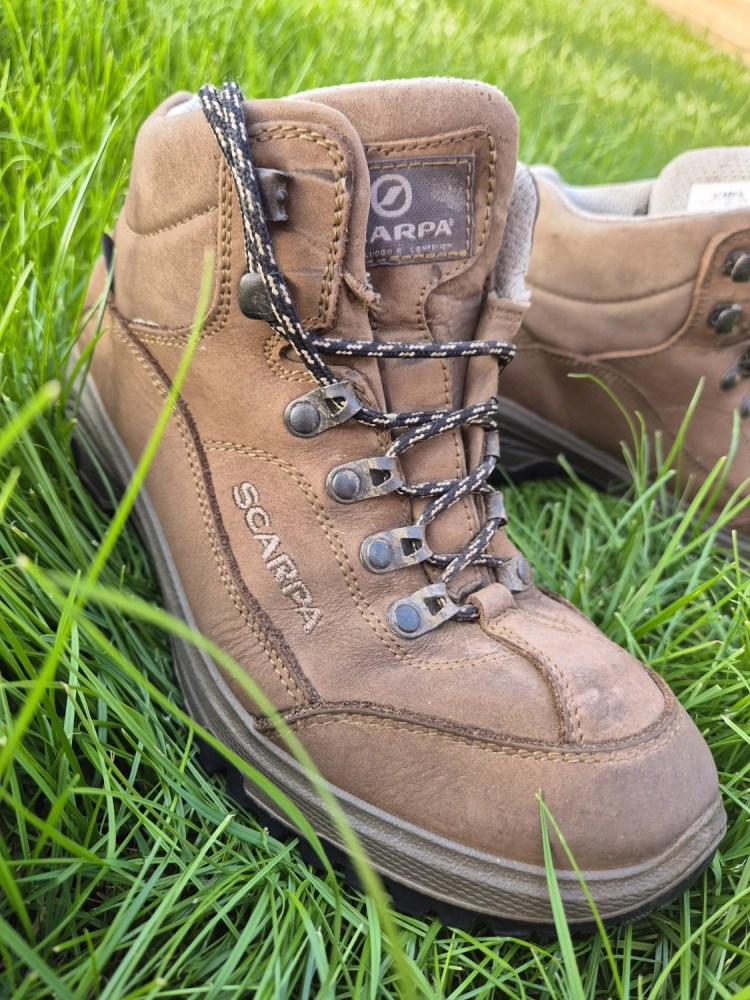 Pair of brown leather walking boots in the grass